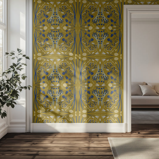 Decorative wall panel with a olive green and blue patterned wallpaper in a room with a couch and plant.