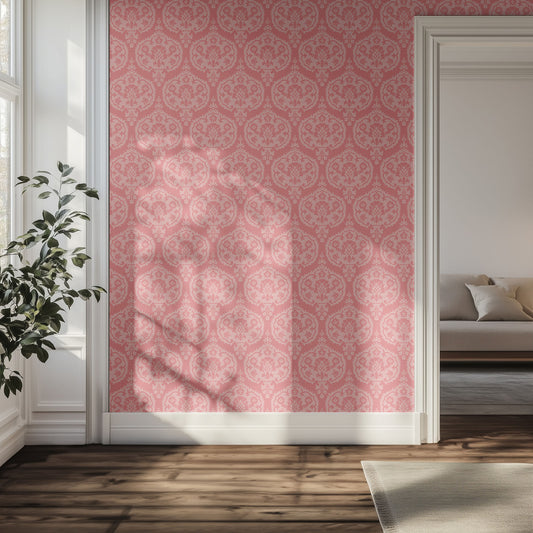 Hallway with pink damask patterned wallpaper, plant, and sofa in the distance.