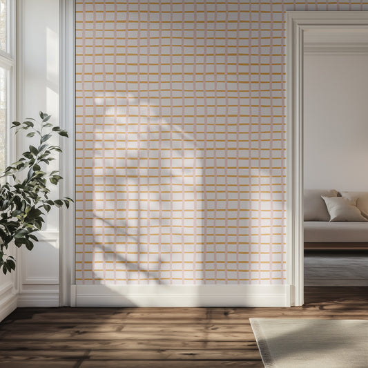 Hallway with light pink and orange grid wallpaper, wooden floor, and a plant.