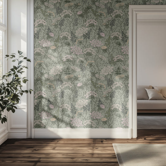 Room interior with sage floral wallpaper, plant, and sofa.