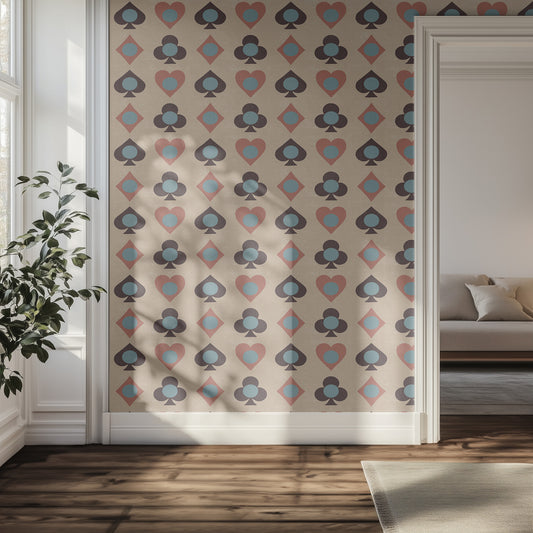 Hallway with patterned wallpaper featuring card suits, a plant, and a sofa.
