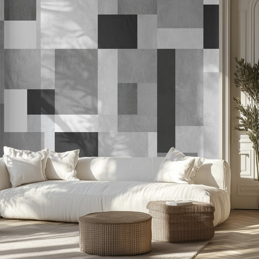 Modern living room with a geometric patterned wall mural, white sofa, and wicker ottomans.