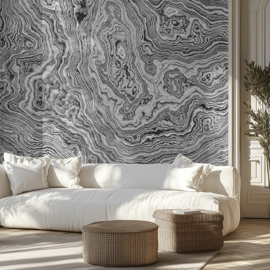Living room with white sofa, marble patterned wallpaper, and wicker ottomans.