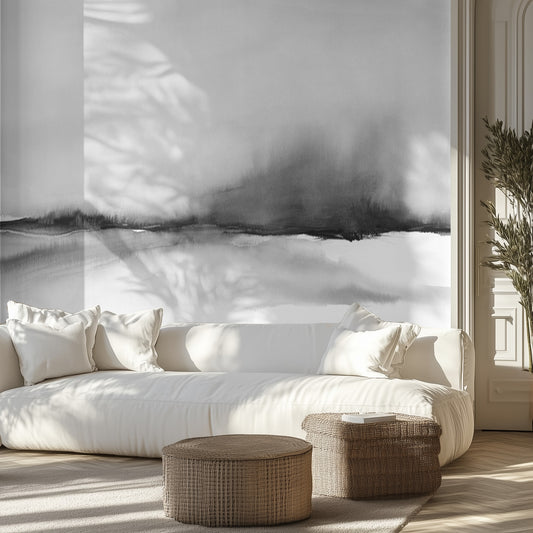 Modern living room with a white sofa, wicker ottomans, and abstract wall mural.