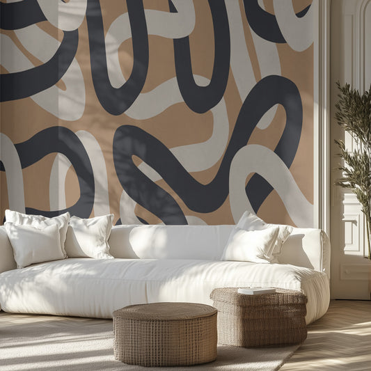 Modern living room with a neutral line art patterned wall, white sofa, and decorative ottomans.