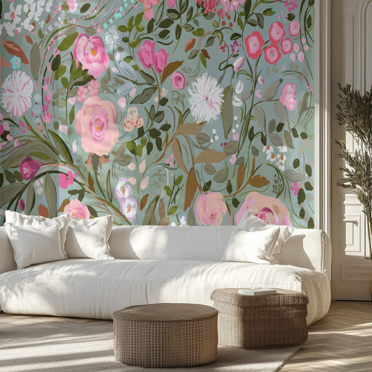 Living room with floral wallpaper mural with a teal background, white sofa, and wicker ottomans.