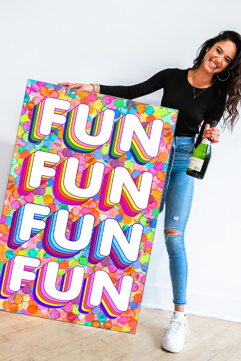 This vibrant and playful "Fun Fun Fun" print by Jessica Stempel. The maximalist wall art features a girl holding a champagne bottle in one hand and the colorful print in the other. The "FUN FUN FUN FUN" text is displayed in a retro bubble font with rainbow dots stamped in the background, creating a fun and playful vibe. This piece is perfect for adding a touch of personality to your maximalist bedroom and will bring a lively energy to your space.