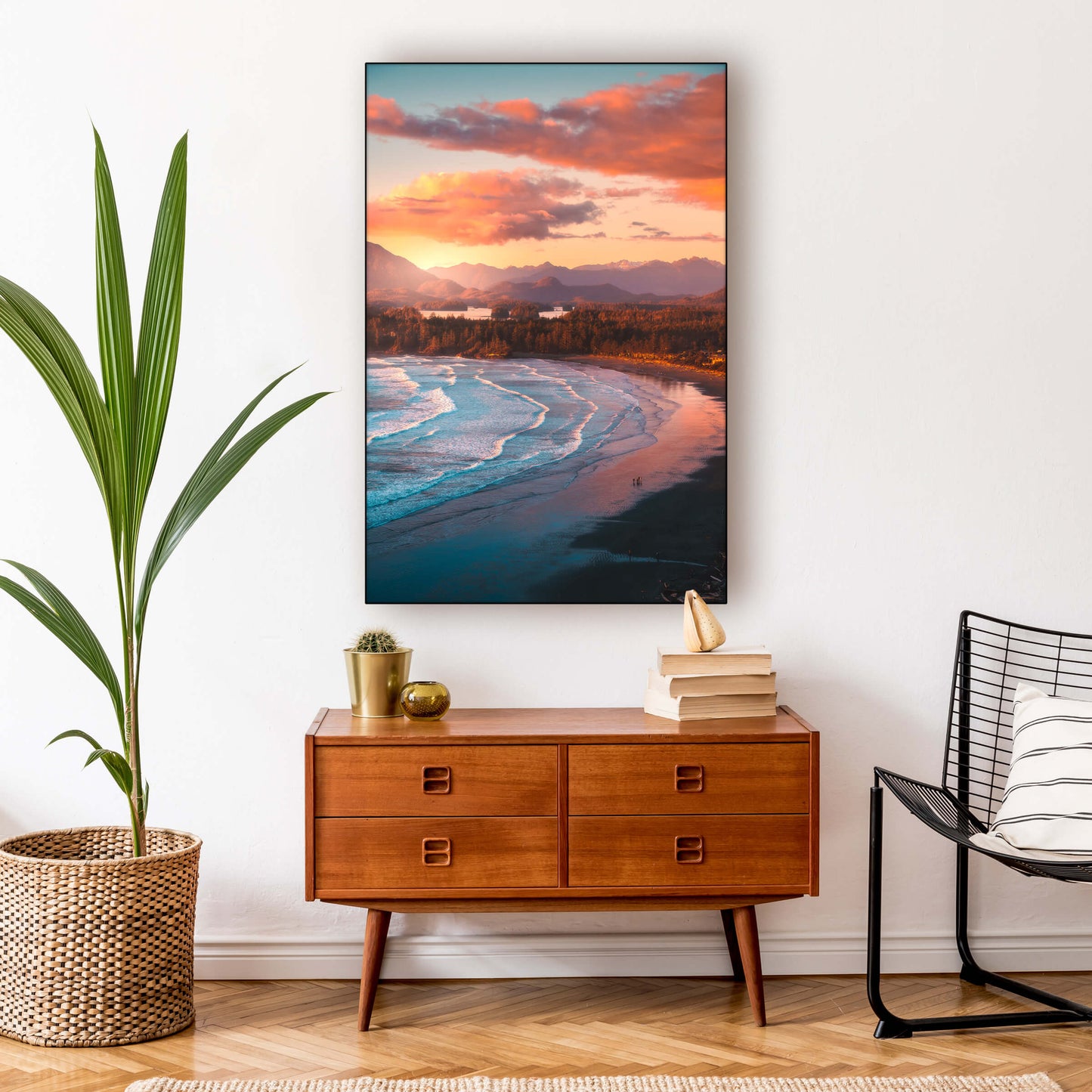 Extra large vertical photo of beach at sunset with vibrant colors hangs in boho living room above wooden side table