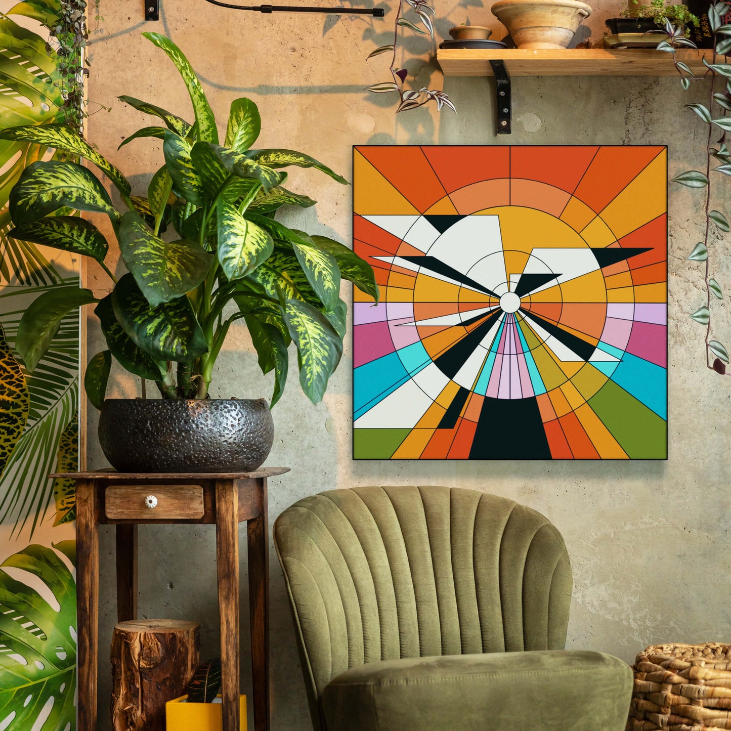 Large boho wall art in orange,yellow, black, white, blue, and green geometric circle hangs above green chair in a boho living room