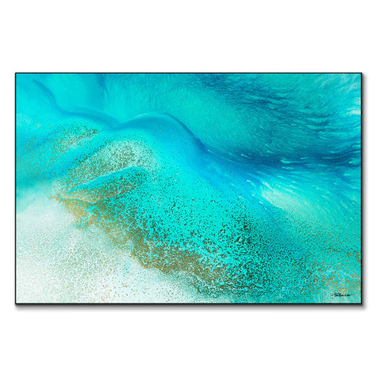 Tropical blue sea water meeting the shore with calming blue and white hues.