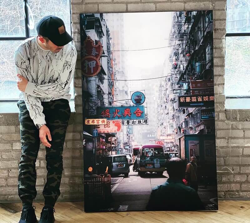 A man looking at a large urban wall art print