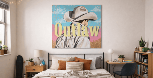 young person's apartment bedroom featuring outlaw stickable art on wall above bed