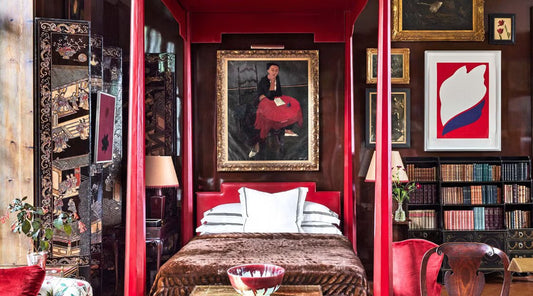 maximalist bedroom with red accents organized in a "cluttercore" fashion.