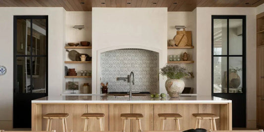 a rustic modern heritage kitchen with m ore modern touches and archways that flank the stove and kitchen island