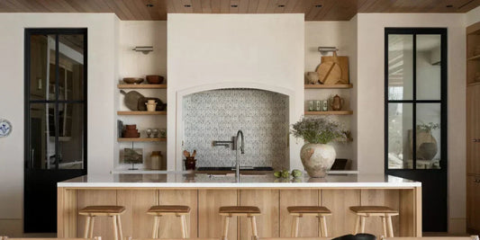 a rustic modern heritage kitchen with m ore modern touches and archways that flank the stove and kitchen island