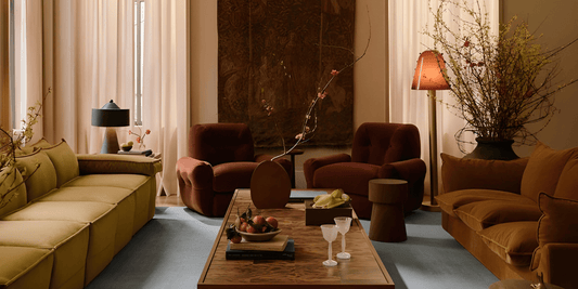 a neo-deco living room furnished with modern furniture and vintage-inspired decor all colored in warm tones