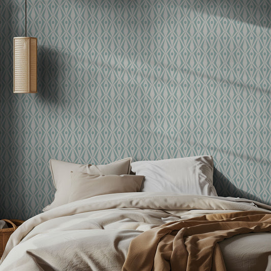 Bedroom with aqua and white geometric patterned wallpaper and soft lighting.