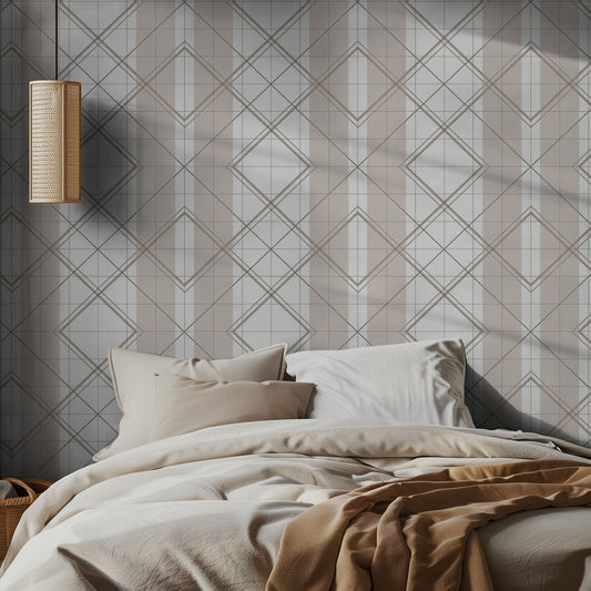 Beige and white geometric wallpaper pattern with diamond shapes and stripes on a bedroom wall, with neutral cozy bedding and a pendant lamp.