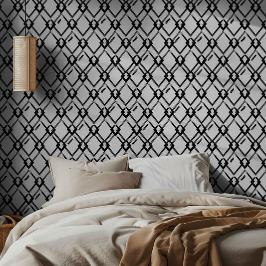 Bedroom with geometric black and white art deco style wallpaper, beige bedding, and a hanging lamp.