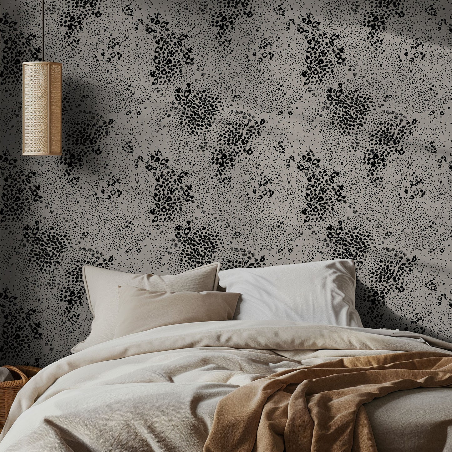 Bedroom with black and beige chetah patterned wallpaper and neutral bedding.