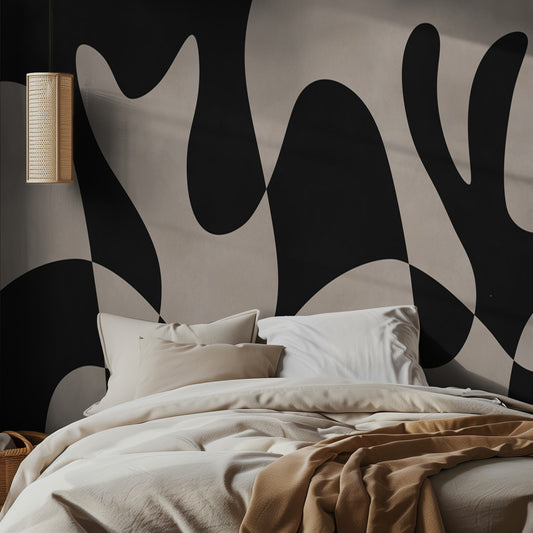 Bedroom with abstract organic black and beige wall design and beige bedding.