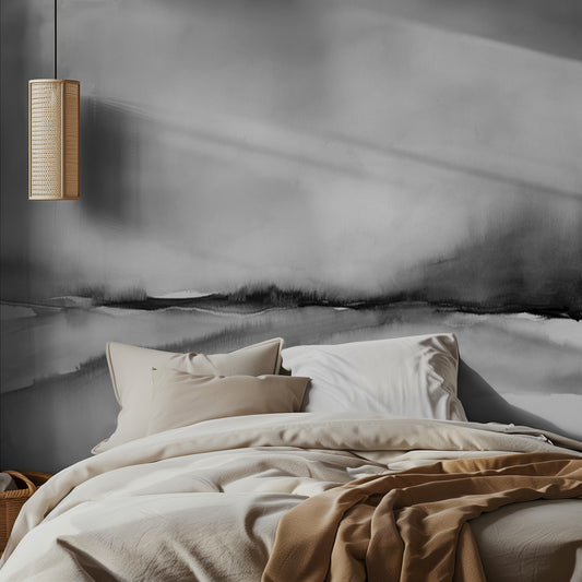 Bedroom with a bed featuring beige and brown bedding, a lamp on the wall, and a gray abstract wall mural.
