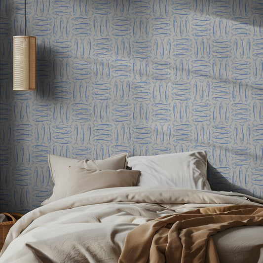 Bedroom with blue sardine wallpaper and neutral bedding and a pendant light.