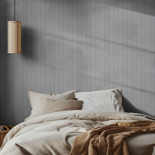 Bedroom with light blue striped patterned wallpaper and soft lighting