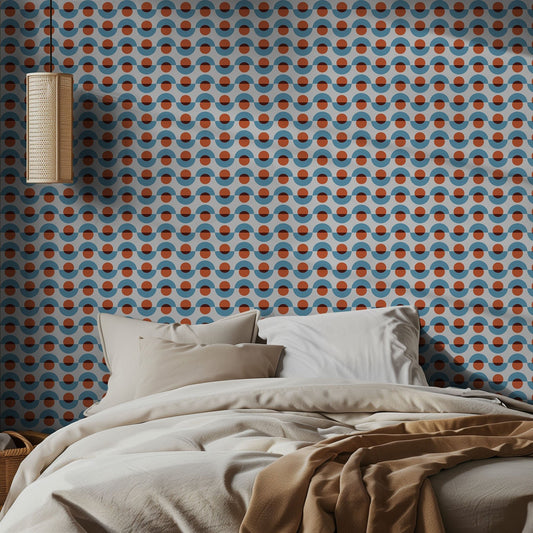 Bedroom with blue and red, midcentury modern geometric patterned wallpaper and neutral bedding.
