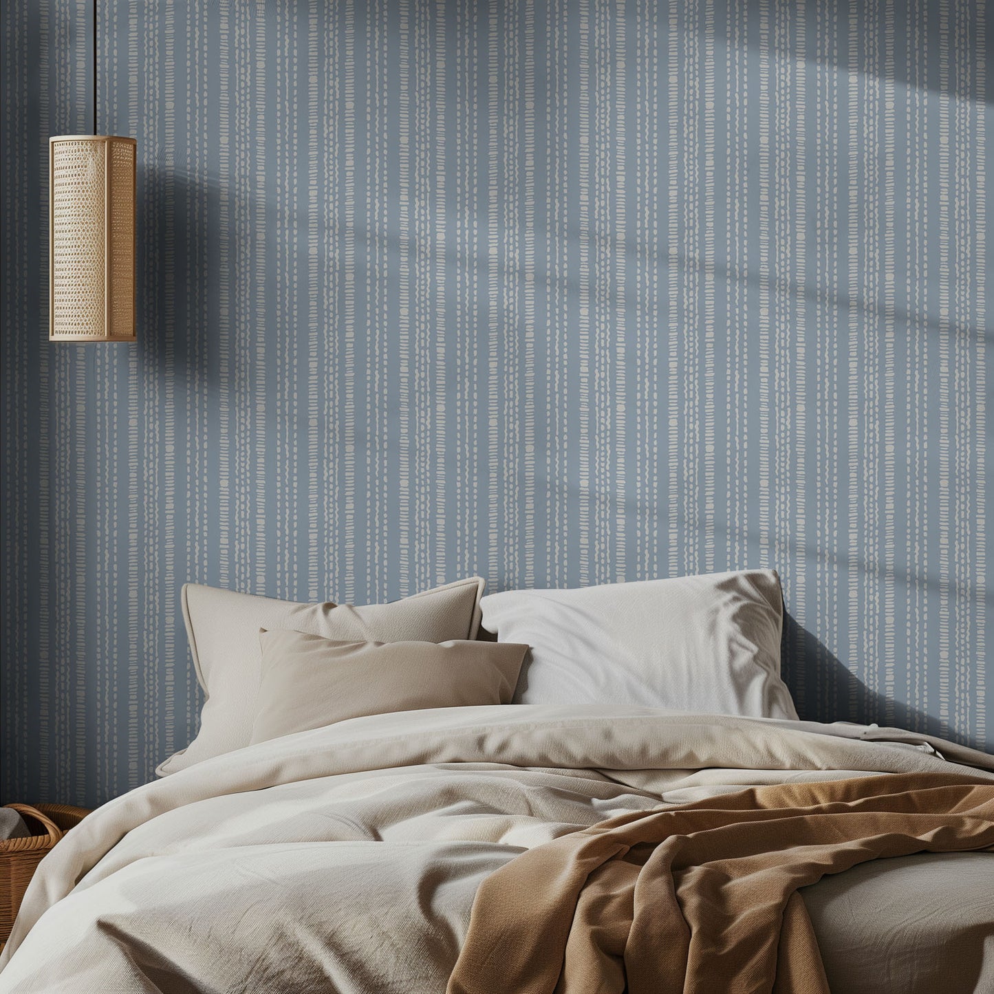 Bedroom with blue and white striped wallpaper, bed with beige bedding, and wall-mounted light fixture.