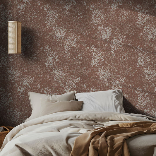 Bedroom with brown and white animal print wallpaper and soft bedding