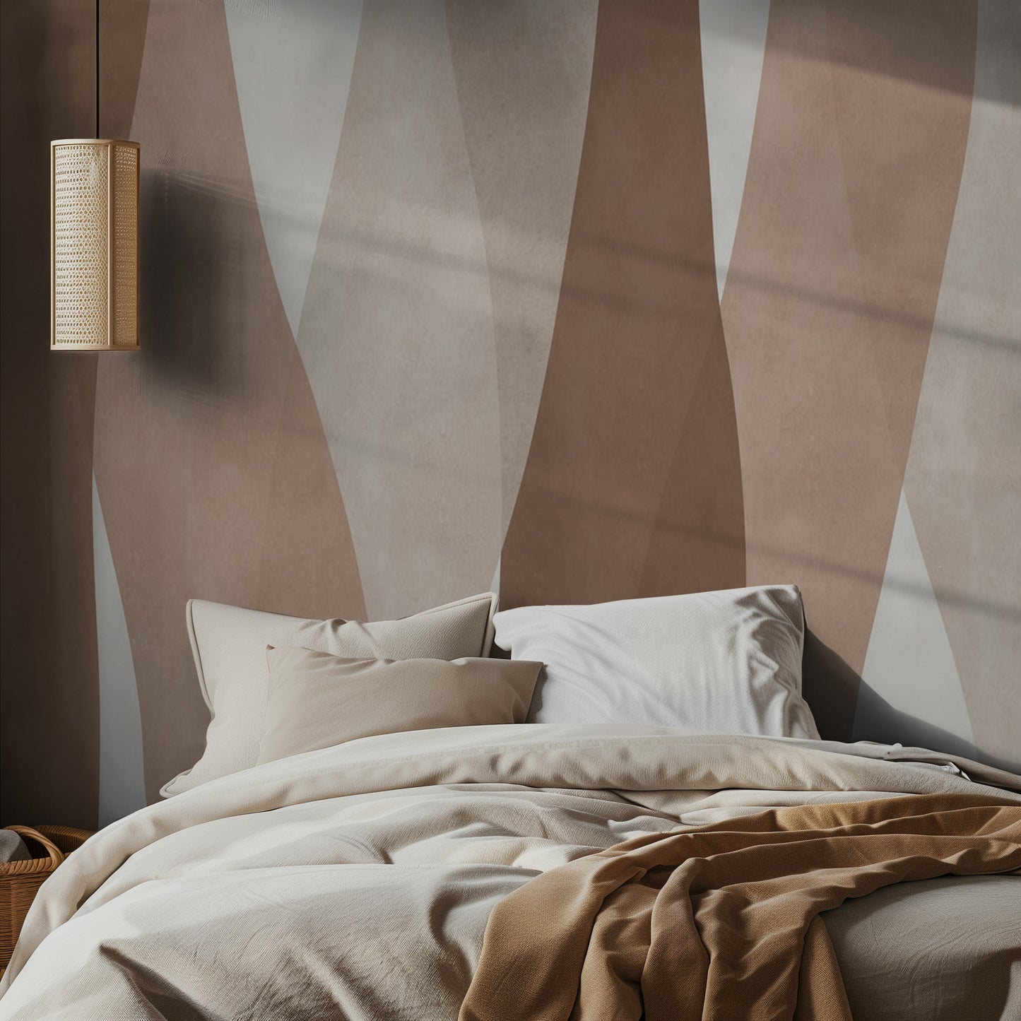 Bed with beige bedding against a wall with abstract brown and beige stripes mural, featuring a lamp on the wall.