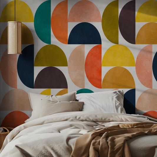 Bedroom with a colorful geometric wall pattern and neutral bedding.