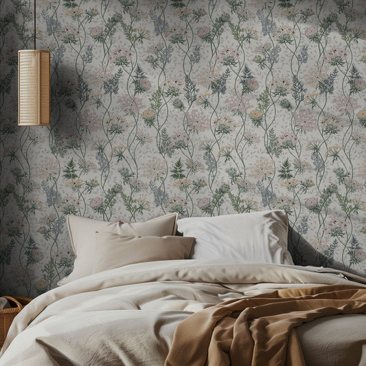 Bedroom with delicate pink and green floral wallpaper and a bed with beige bedding.