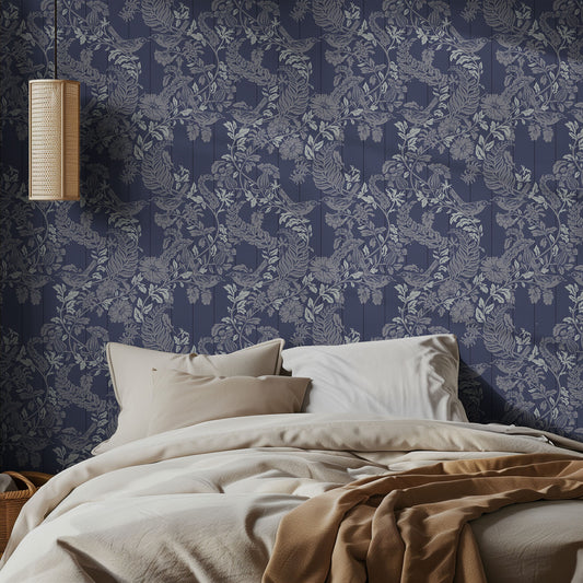 Bedroom with blue floral wallpaper and a bed with beige bedding.