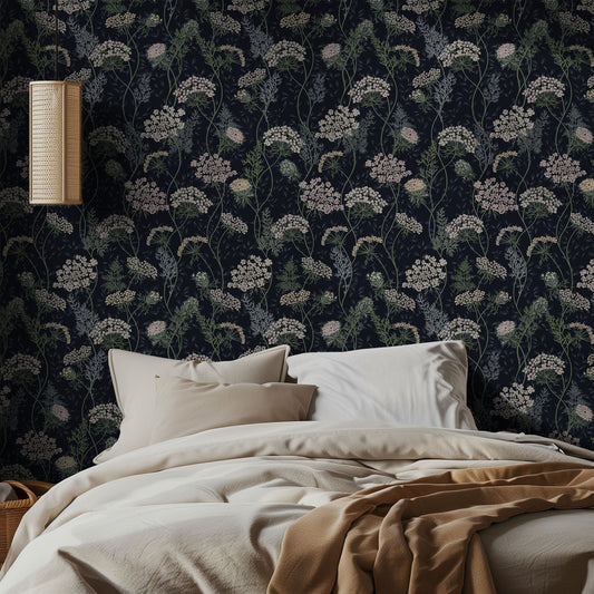 Bedroom with dark navy floral wallpaper and beige bedding