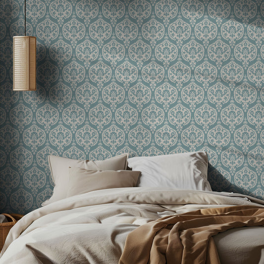Bedroom with teal and white damask wallpaper patterned walls with neutral bedding.