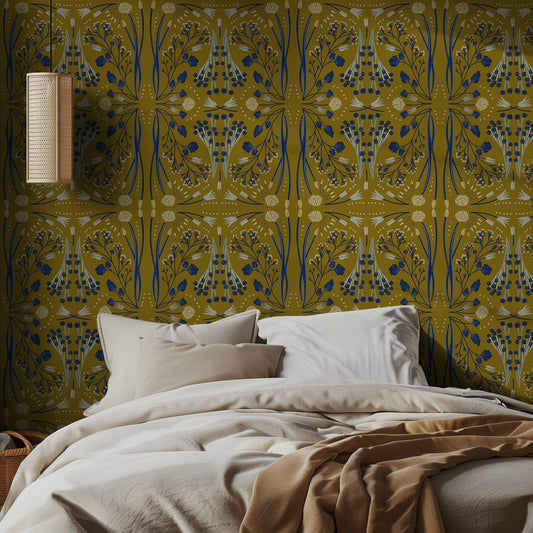 Bedroom with a patterned olive green wall and bed with beige bedding.
