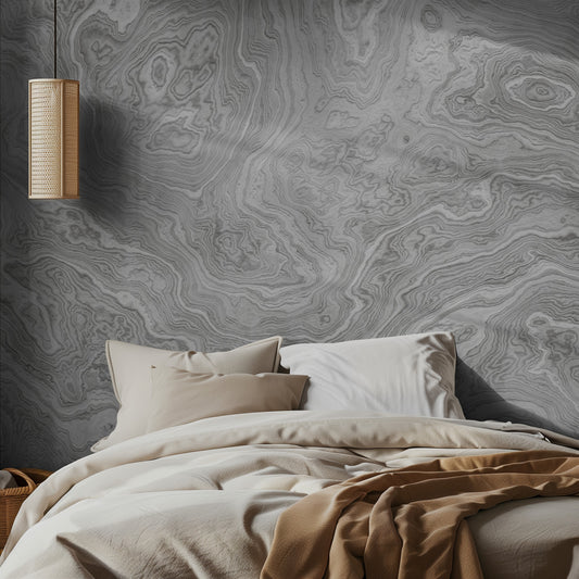 Bedroom with light marble-patterned wallpaper and a hanging light fixture.