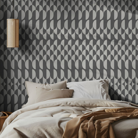 Bedroom with gray geometric patterned wallpaper and neutral bedding.
