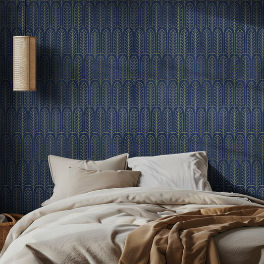 Bedroom with blue art deco patterned wallpaper, beige bedding, and a lamp.