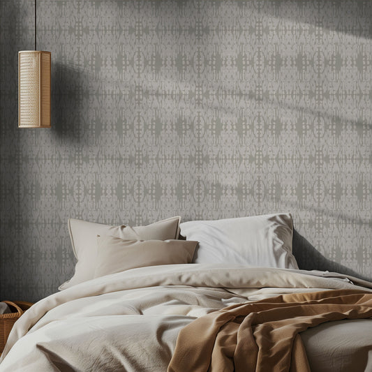 Bedroom with ikat boho sage green and white patterned wallpaper and soft bedding