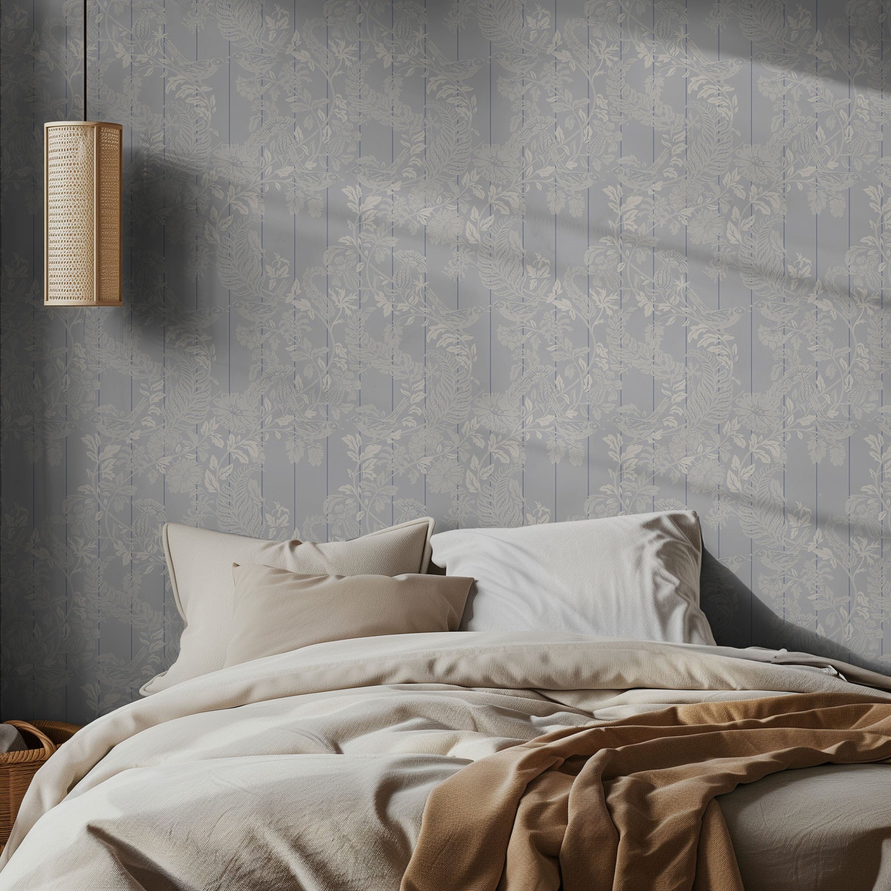 Bedroom with floral wallpaper, bed with beige bedding, and wall-mounted lamp.