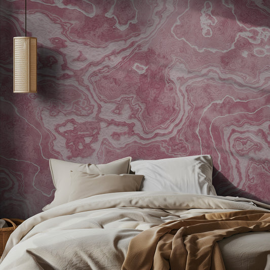 Bedroom with pink marble-patterned wallpaper and beige bedding.