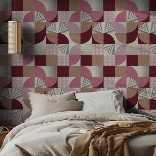 Bedroom with midcentury pink geometric patterned wallpaper and soft lighting.