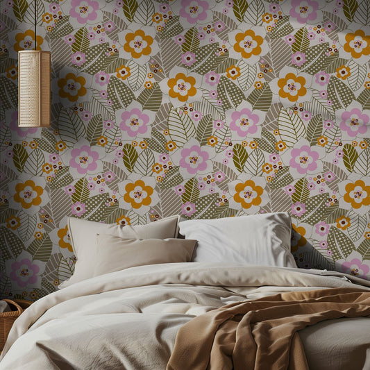 Bedroom with pink orange and green floral wallpaper and a bed with beige bedding.