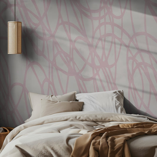 Bedroom with abstract pink and gray wall pattern, beige bedding, and pendant light.