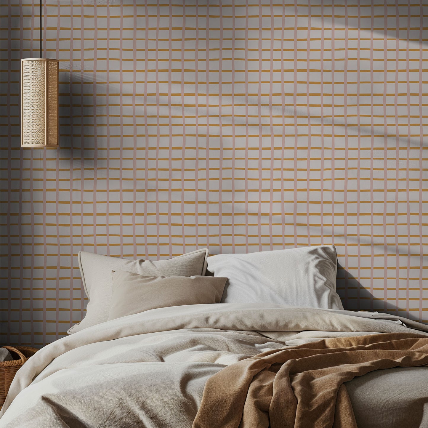 Bedroom with beige bedding and a orange pink grid geometric wall pattern