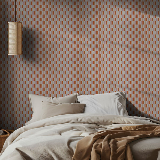 Bedroom with pink and orange geometric patterned wallpaper and soft lighting.