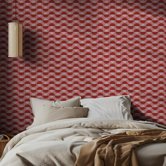 Bedroom with red retro geometric wallpaper and beige bedding.